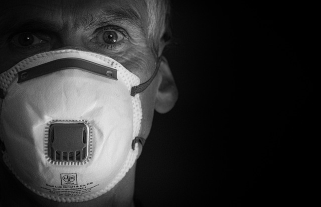 Old man in a mask. Black and white picture.